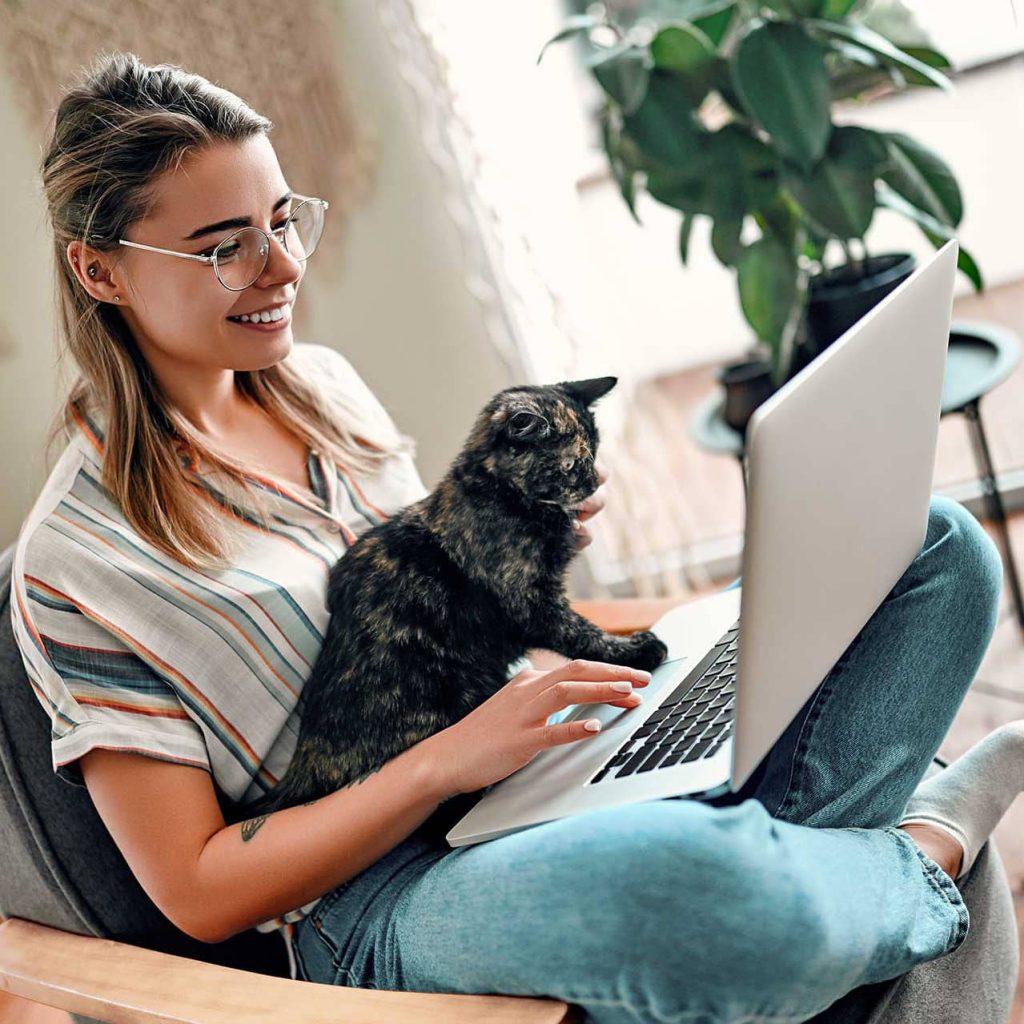 Therapist with their cat happy because they can add a client portal to their therapist website